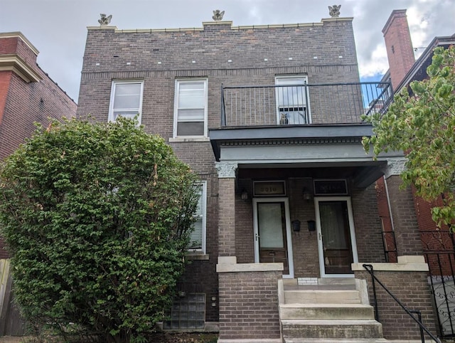 view of front of property with a balcony and central AC