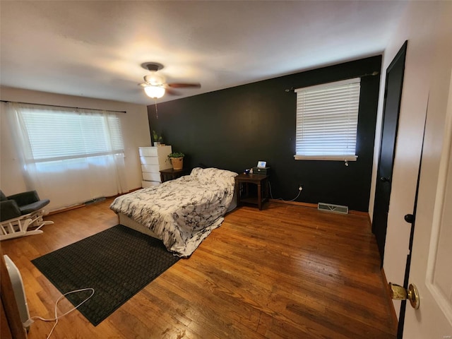 bedroom with ceiling fan and hardwood / wood-style floors