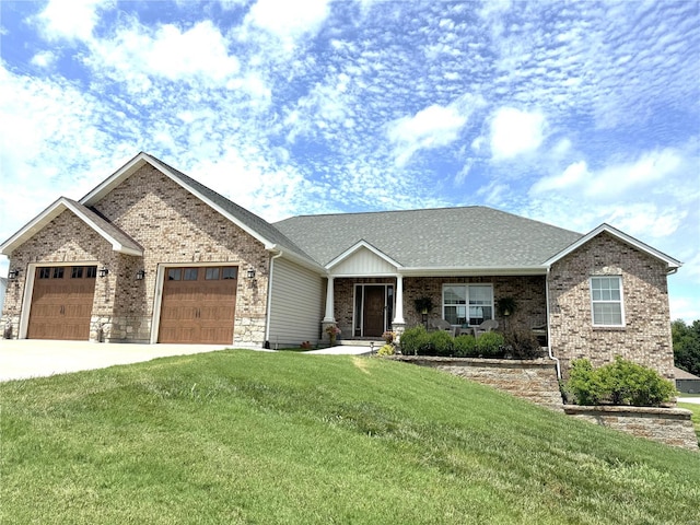 view of front of house featuring a front lawn and a garage