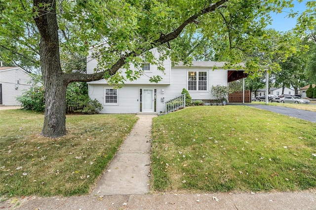 split level home featuring a front yard and a carport