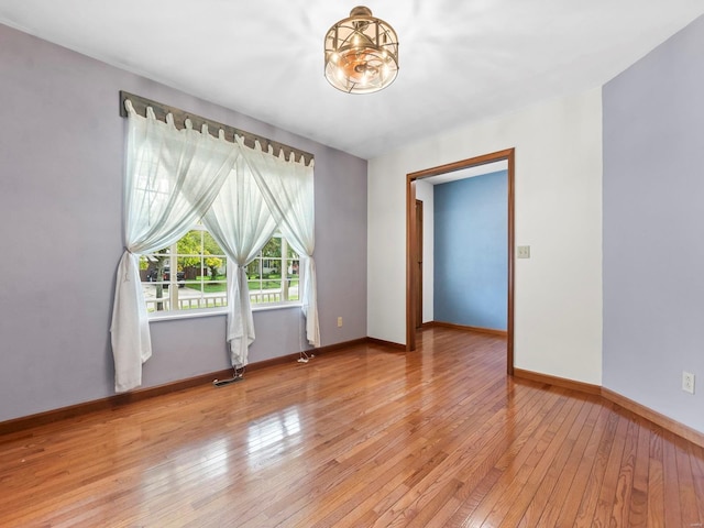 unfurnished room with hardwood / wood-style floors