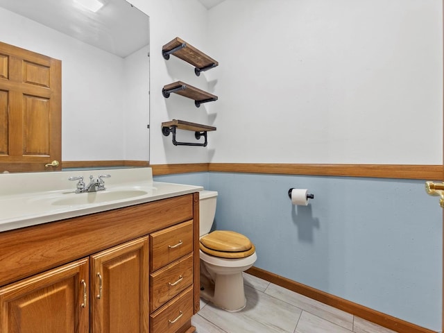 bathroom with tile patterned floors, vanity, and toilet