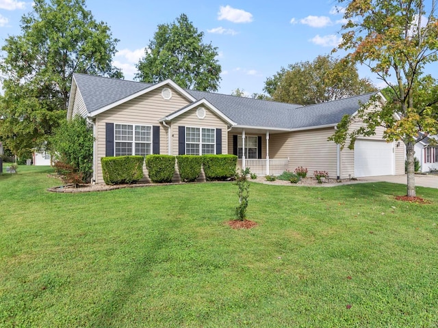 ranch-style home with covered porch, a front yard, and a garage