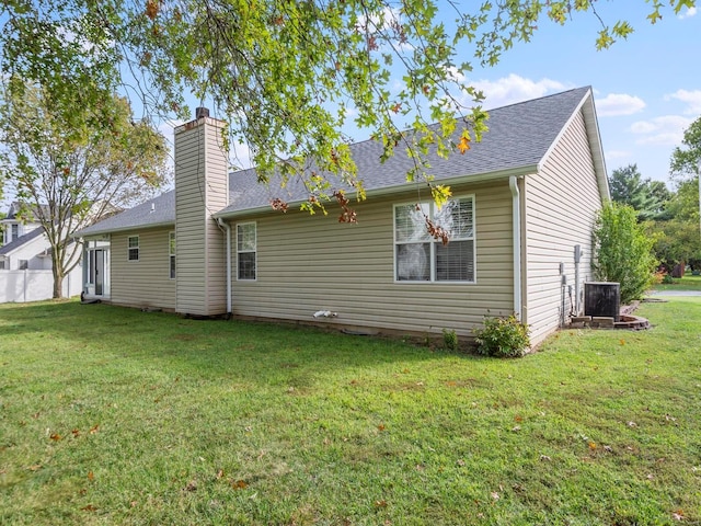 back of house with a yard and cooling unit