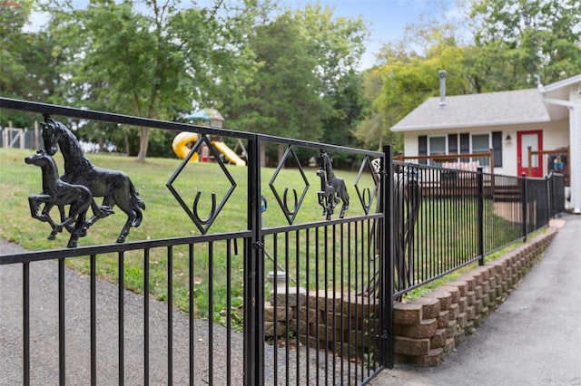 view of gate featuring a lawn