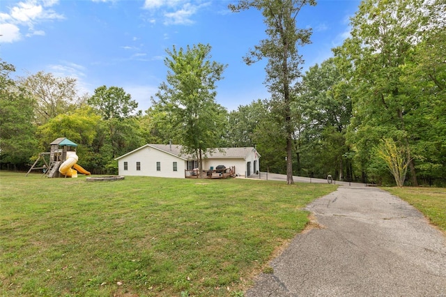 view of front of house with a front yard and a playground