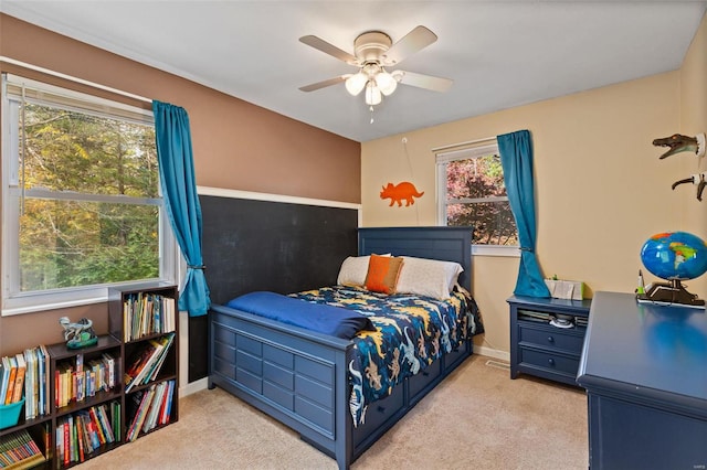 bedroom featuring light colored carpet and ceiling fan