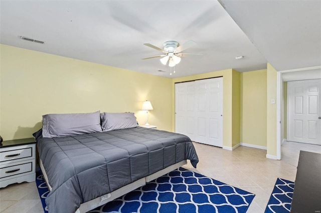 tiled bedroom with a closet and ceiling fan