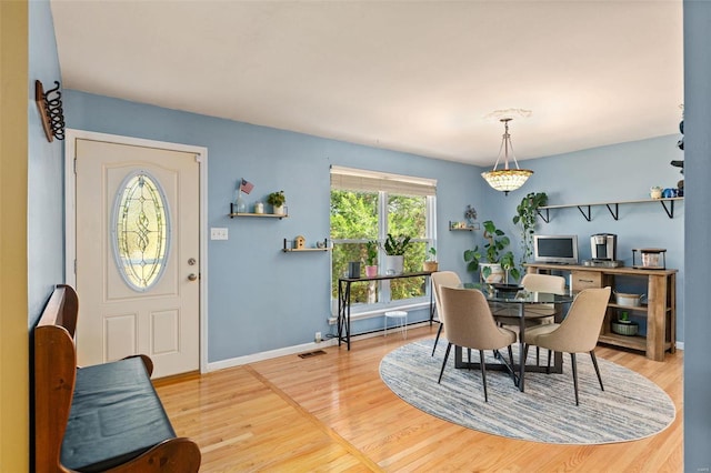 dining space with hardwood / wood-style floors