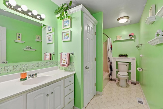 full bathroom featuring toilet, vanity, and shower / bath combination with curtain