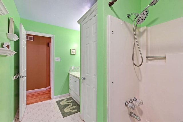 bathroom with vanity and shower / bathing tub combination