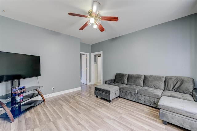 living room with ceiling fan and light wood-type flooring