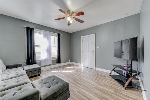 living room with ceiling fan and light hardwood / wood-style flooring