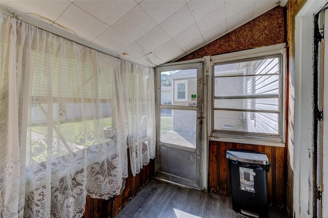 unfurnished sunroom featuring lofted ceiling