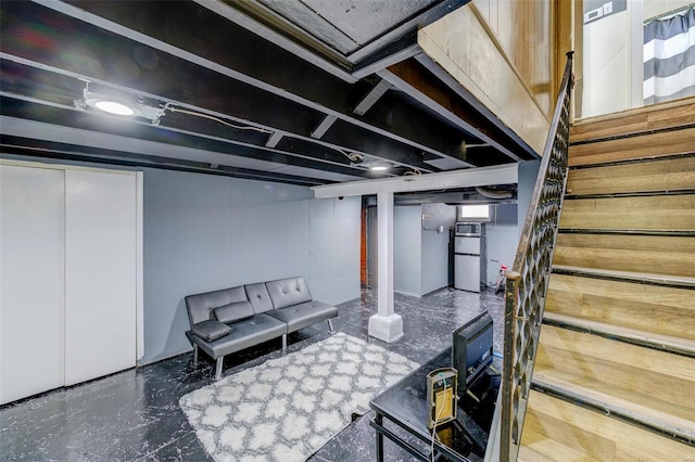 basement featuring stainless steel refrigerator