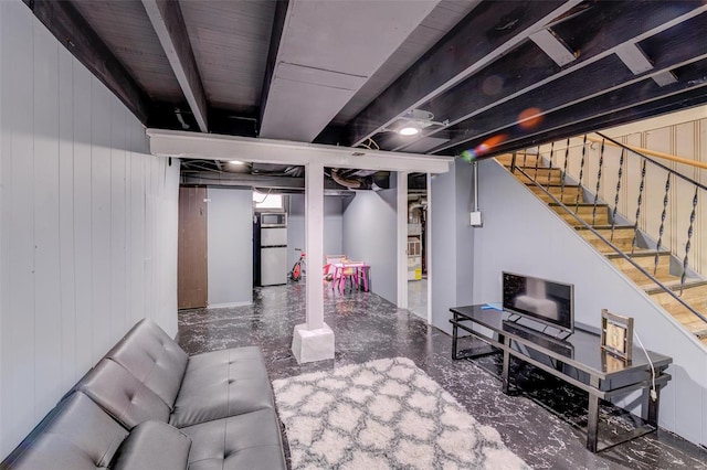 basement with fridge and wooden walls