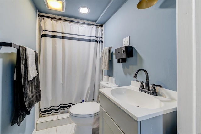 bathroom featuring curtained shower, tile patterned flooring, vanity, and toilet