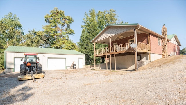 back of property featuring an outdoor structure and a garage