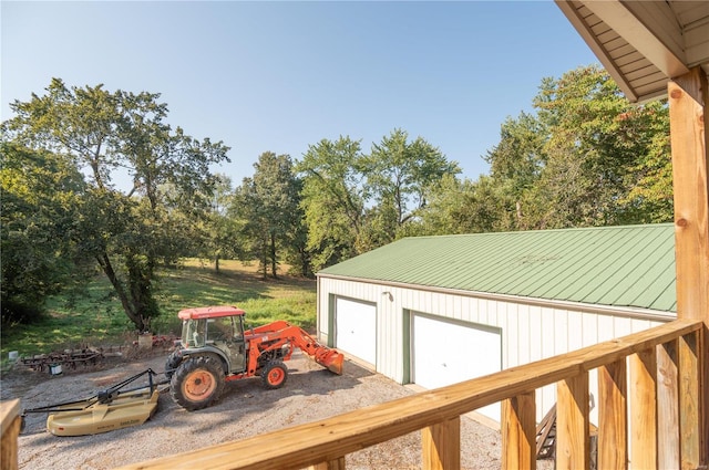 exterior space with a garage and an outbuilding