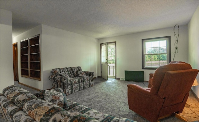 carpeted living room featuring a textured ceiling