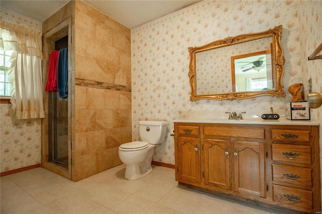 bathroom with a textured ceiling, walk in shower, vanity, and toilet