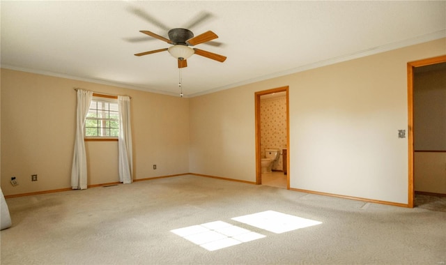 carpeted spare room featuring ornamental molding and ceiling fan