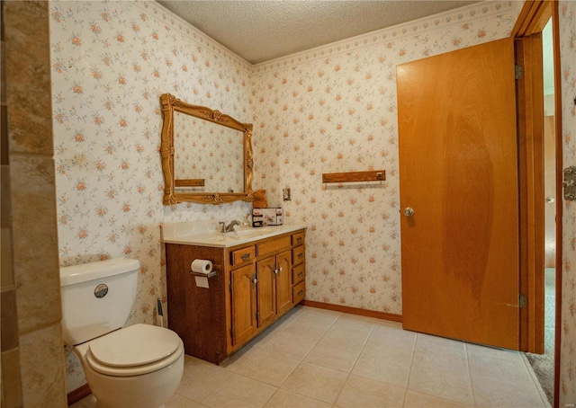 bathroom with a textured ceiling, tile patterned flooring, vanity, and toilet