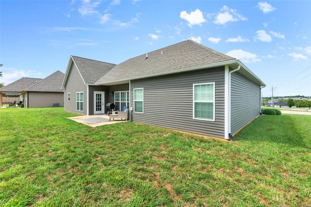 back of property with a patio area and a yard