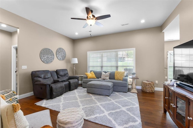 living room with ceiling fan and dark wood-type flooring