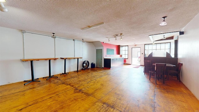 miscellaneous room featuring a skylight and a textured ceiling