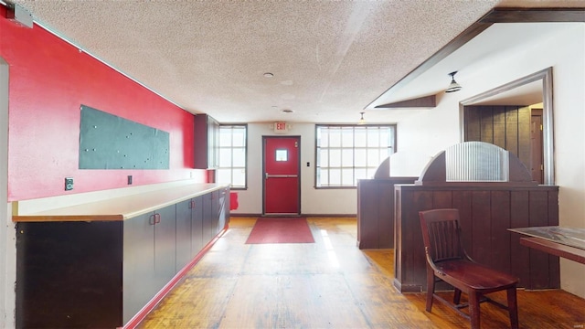 interior space with light wood-type flooring and a textured ceiling