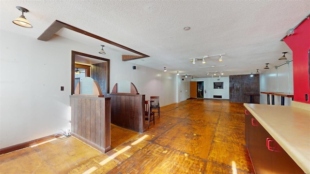 corridor featuring a textured ceiling