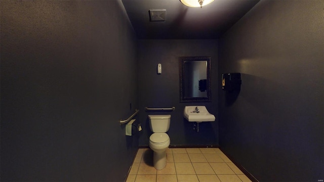 bathroom featuring tile patterned floors, toilet, and sink