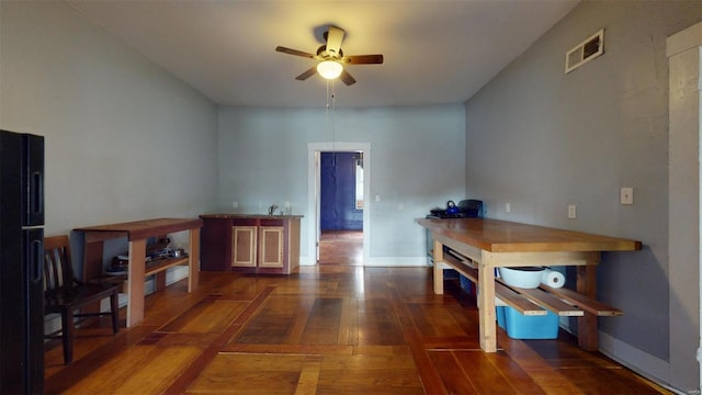 interior space featuring ceiling fan and dark hardwood / wood-style flooring