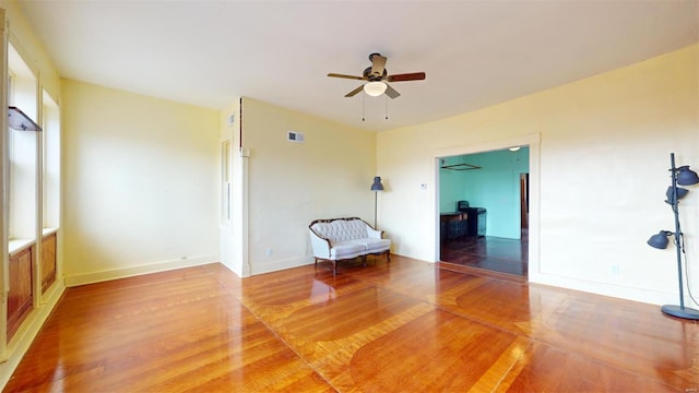 unfurnished room featuring ceiling fan and hardwood / wood-style floors