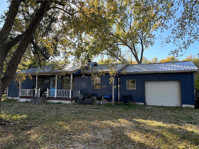 ranch-style house featuring a porch, a front lawn, and a garage