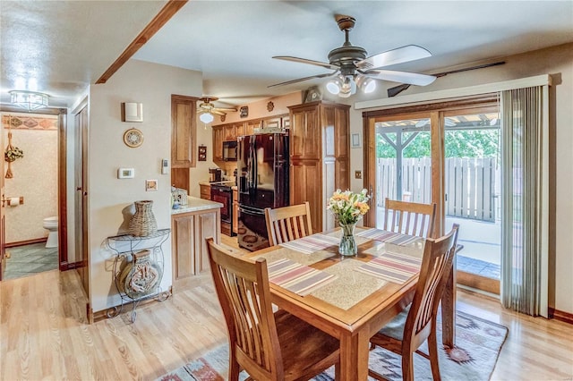 dining area featuring light wood-type flooring and ceiling fan