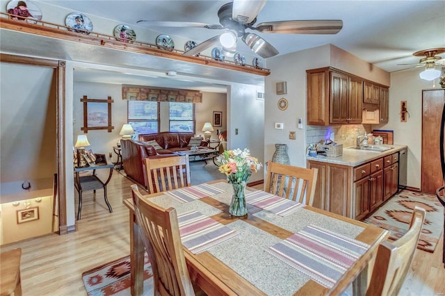 dining room with ceiling fan, light hardwood / wood-style floors, and sink