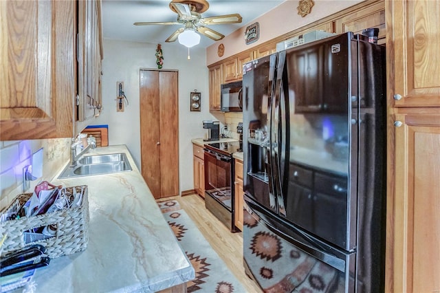 kitchen with ceiling fan, sink, black appliances, light hardwood / wood-style floors, and decorative backsplash