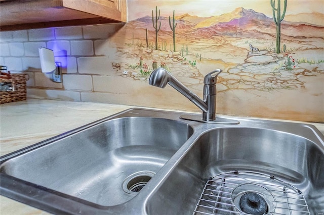 details featuring sink and decorative backsplash