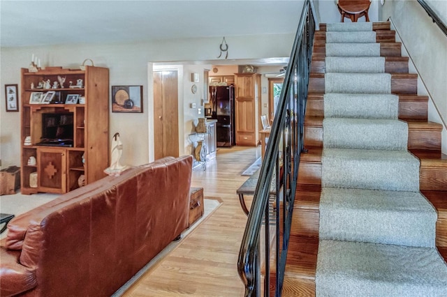 stairs featuring hardwood / wood-style floors