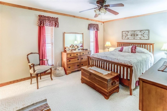 carpeted bedroom with ceiling fan and ornamental molding