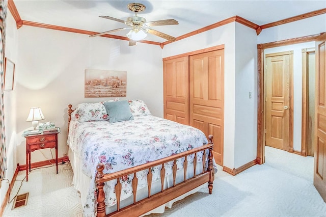 bedroom with light carpet, a closet, ceiling fan, and crown molding