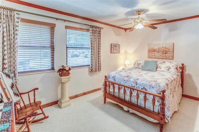 carpeted bedroom featuring ceiling fan and ornamental molding