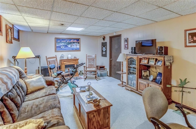 carpeted living room with a drop ceiling