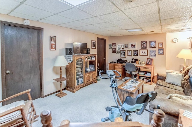 living room with a paneled ceiling and carpet flooring