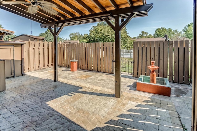 view of patio featuring ceiling fan and a storage shed