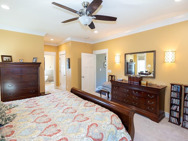 carpeted bedroom with ornamental molding, ensuite bathroom, and ceiling fan