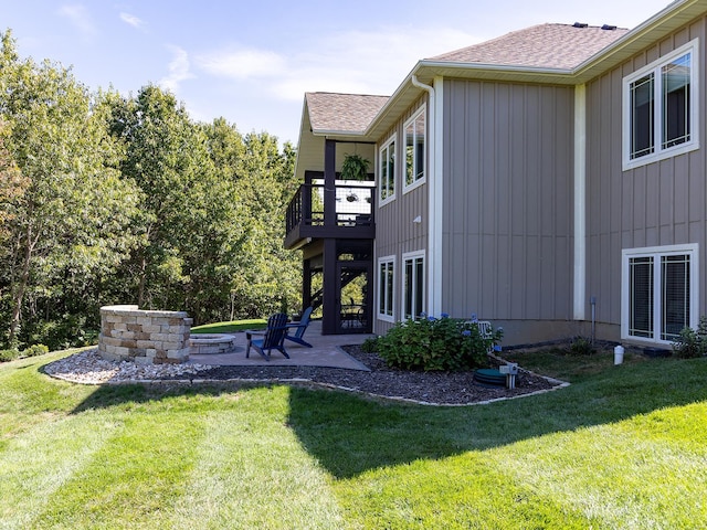 view of yard featuring a balcony and a patio