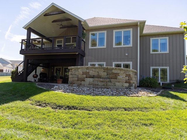 rear view of house featuring a yard, a patio, and a wooden deck